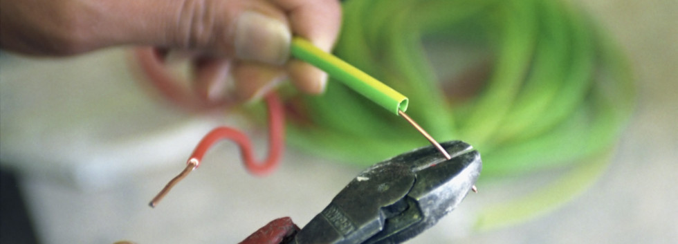 ,  , --- Electrician Stripping Electrical Wire --- Image by © Construction Photography/Corbis